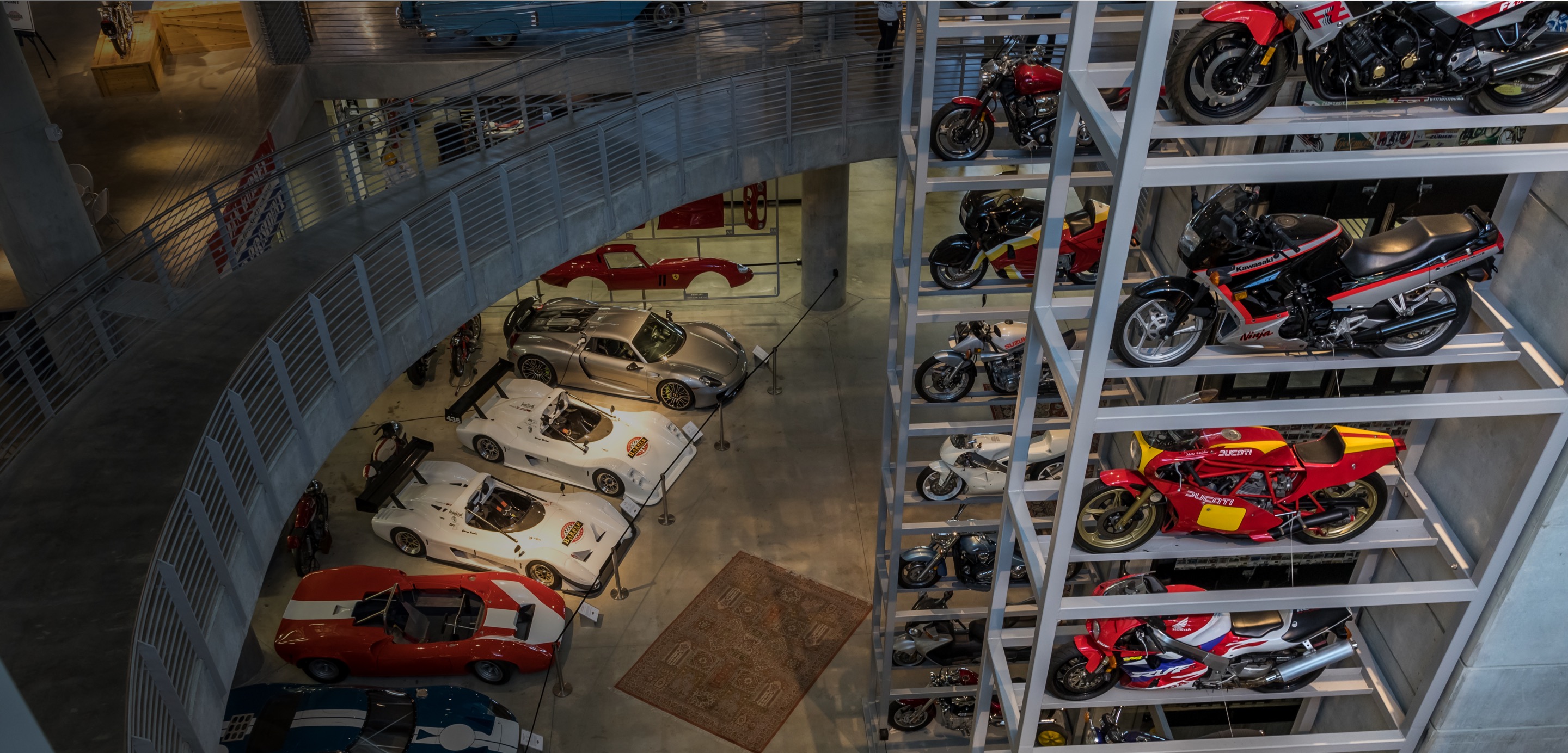 Bird's eye view of vintage race cars and motorcycles inside the Barber Vintage Motorsports Museum