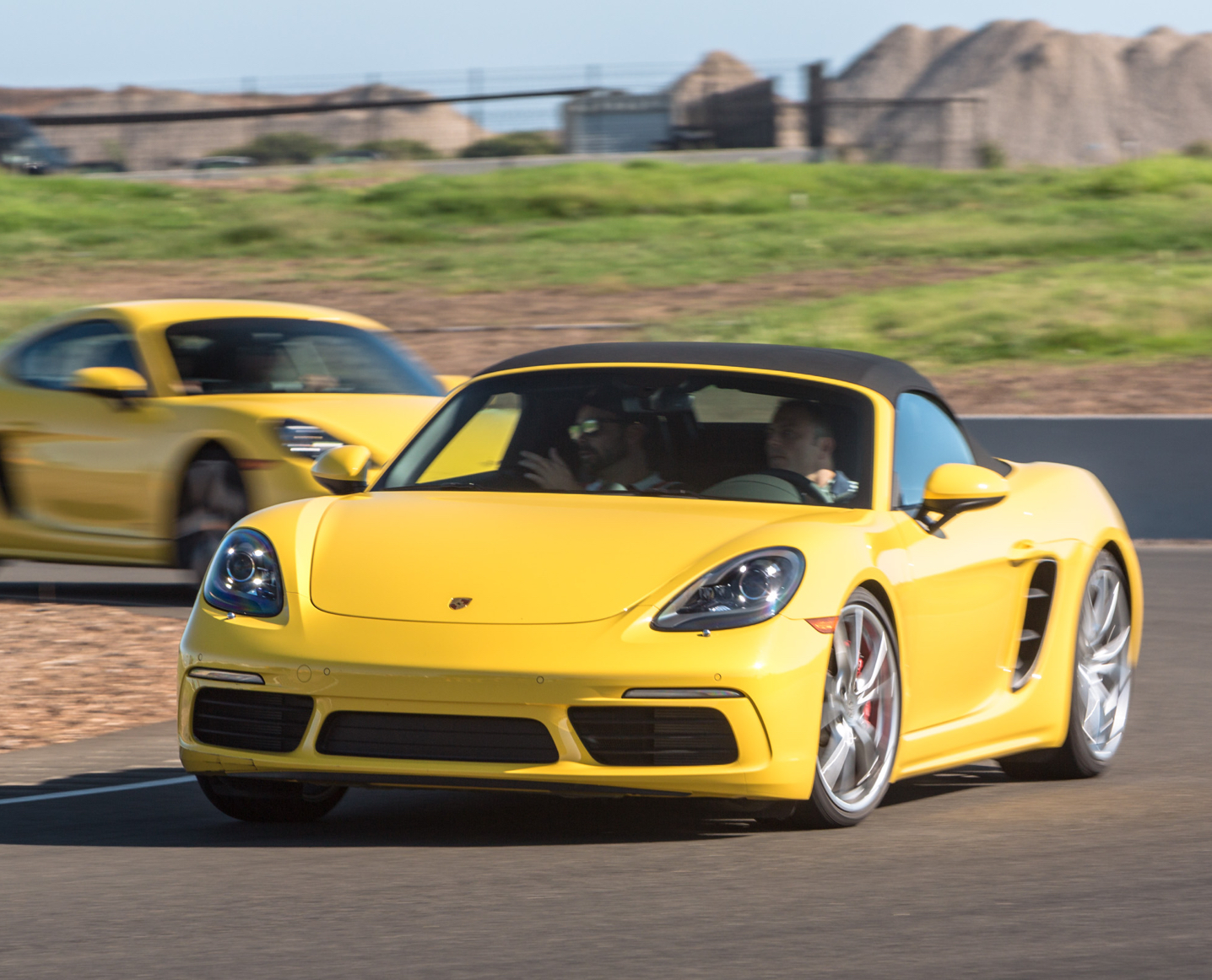 Yellow 718 boxster driving 