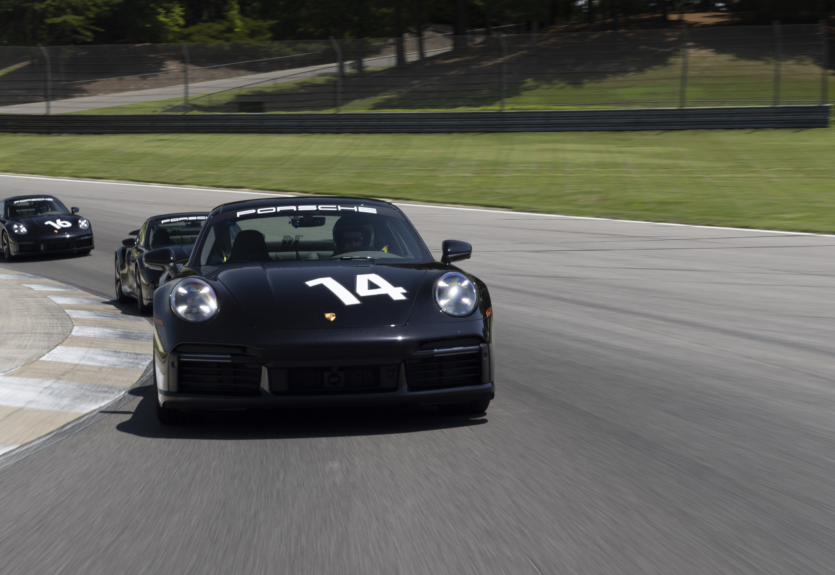 Level one courses, intro background - blue porshe cars on track