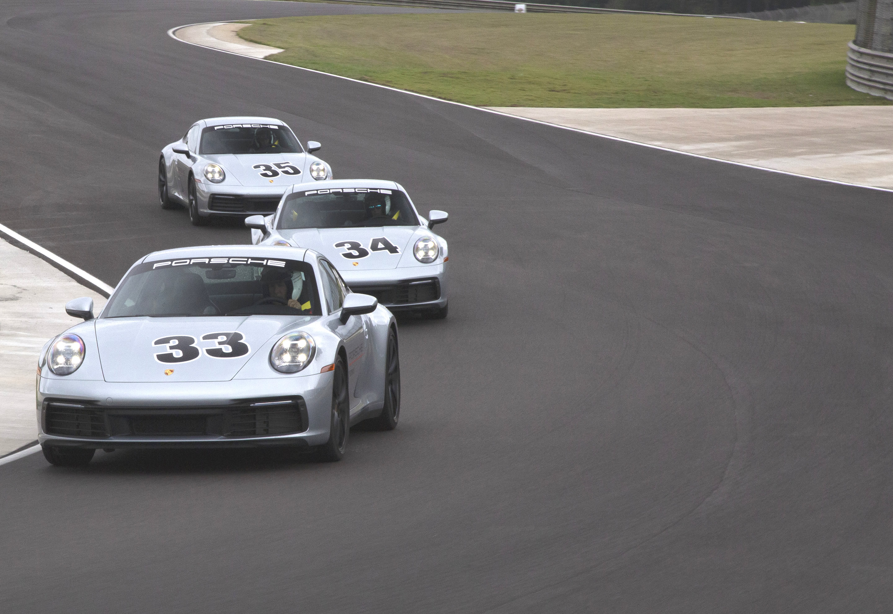 Level one courses, intro background - blue porshe cars on track