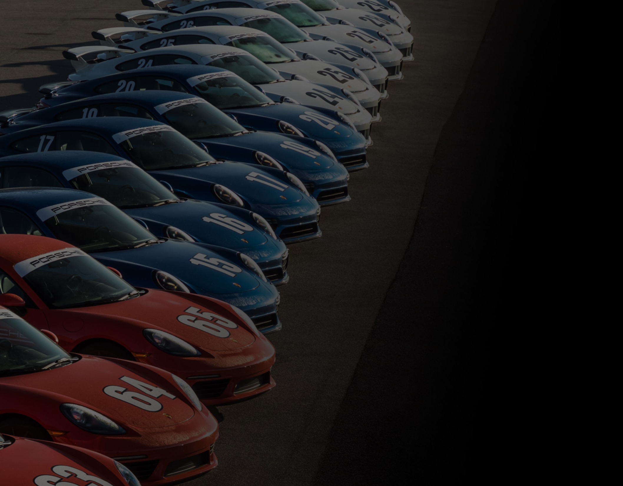 Itinerary background image - red, white and blue porsches lined up
